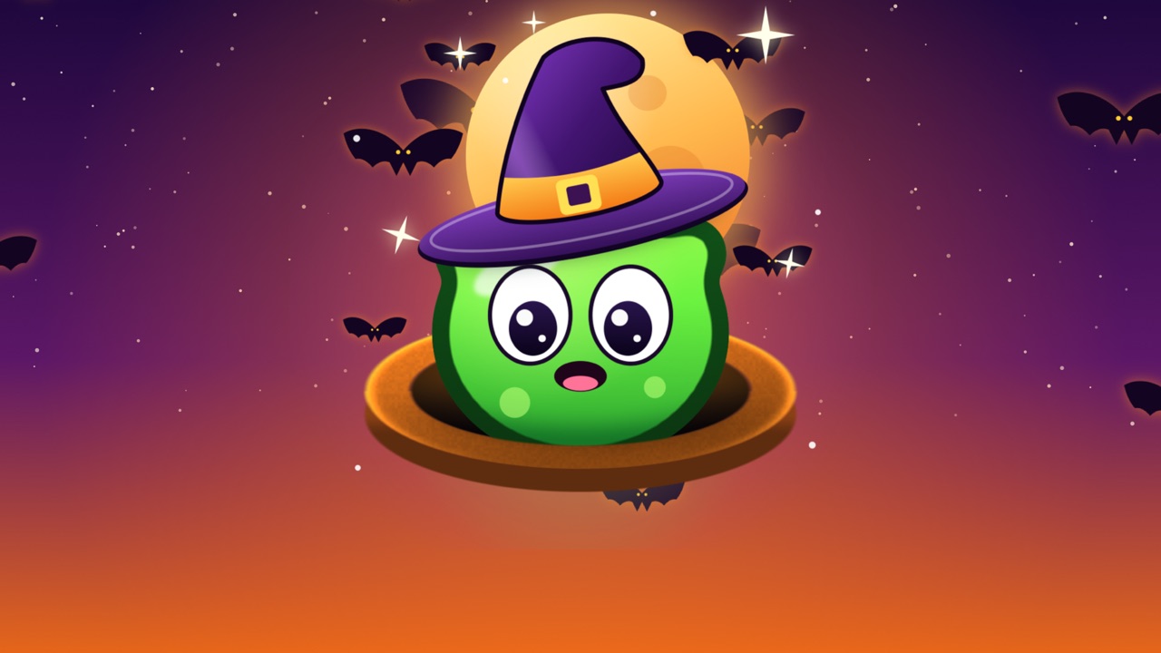 A green alien in a witch hat peeking out of its hole under a big orange moon, with bats flying around